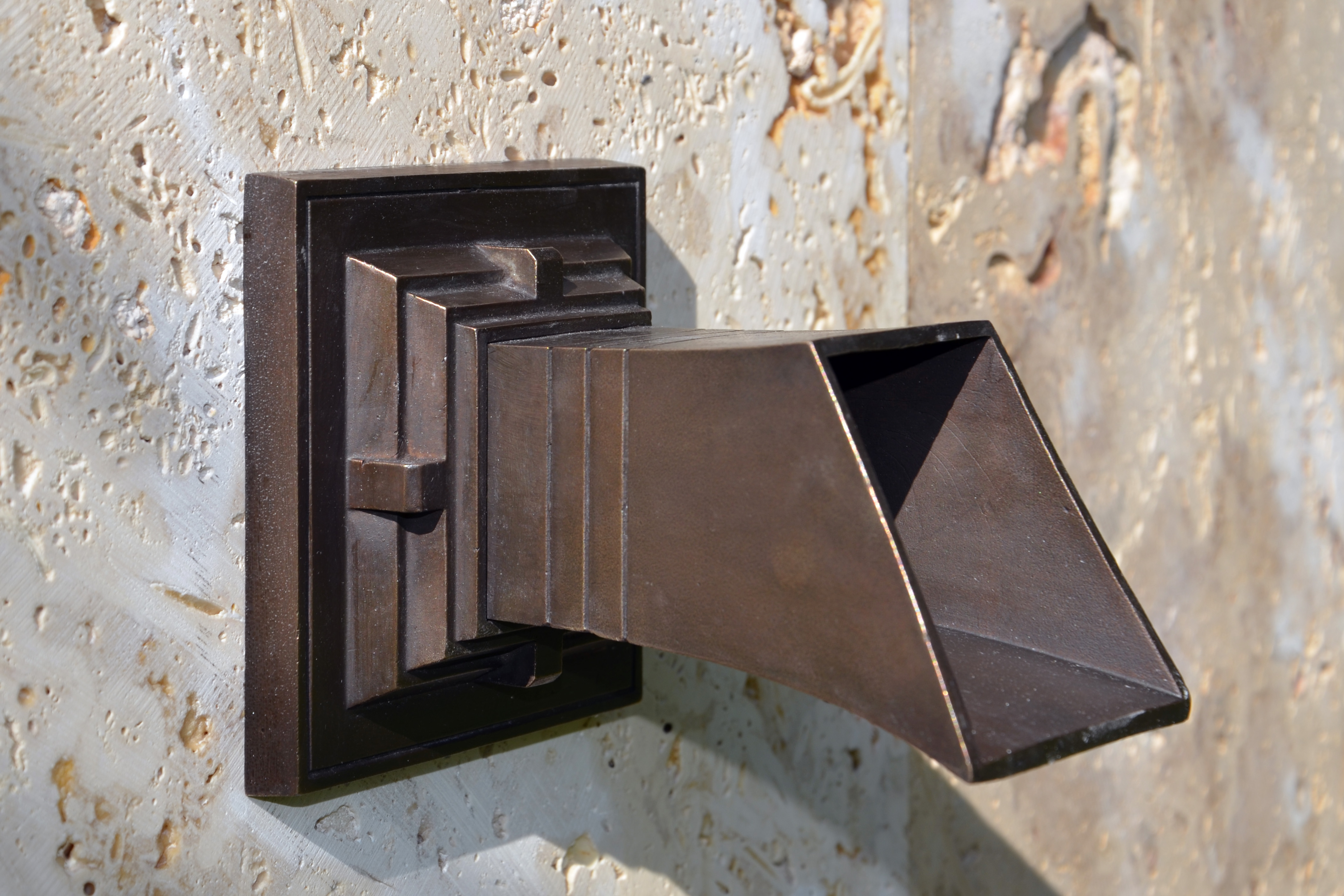 bronze fountain spout on a stone background